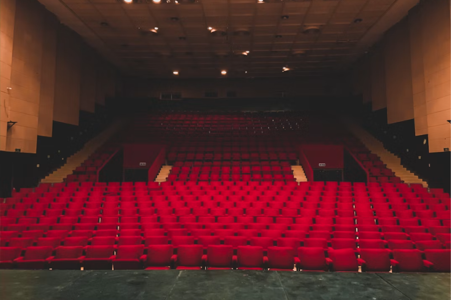 Rows of red seats in a historic theatre auditorium